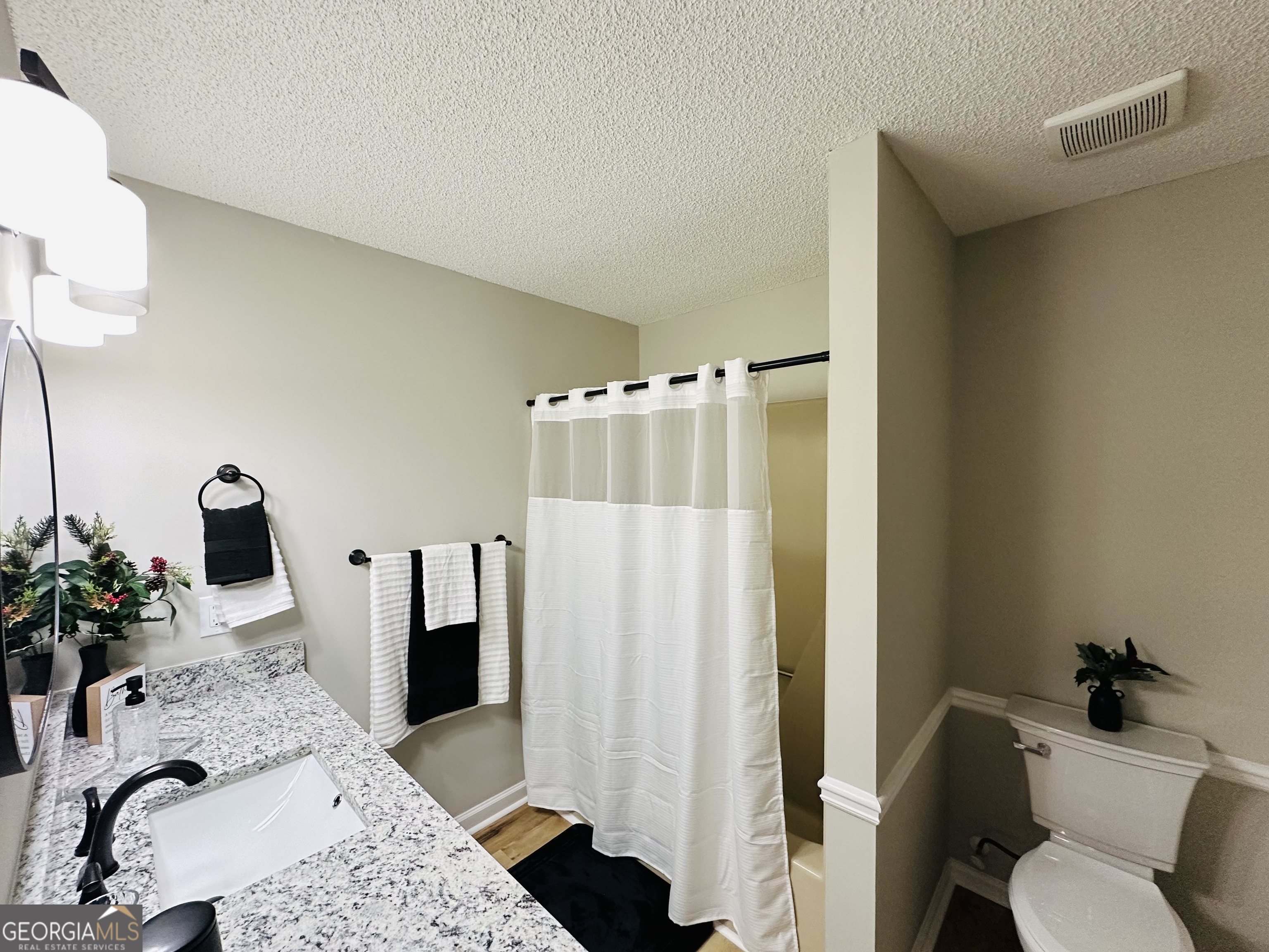 1610 Lance Drive Dublin, GA 31021 - Photo 31 of 38 a bathroom with a sink toilet and shower