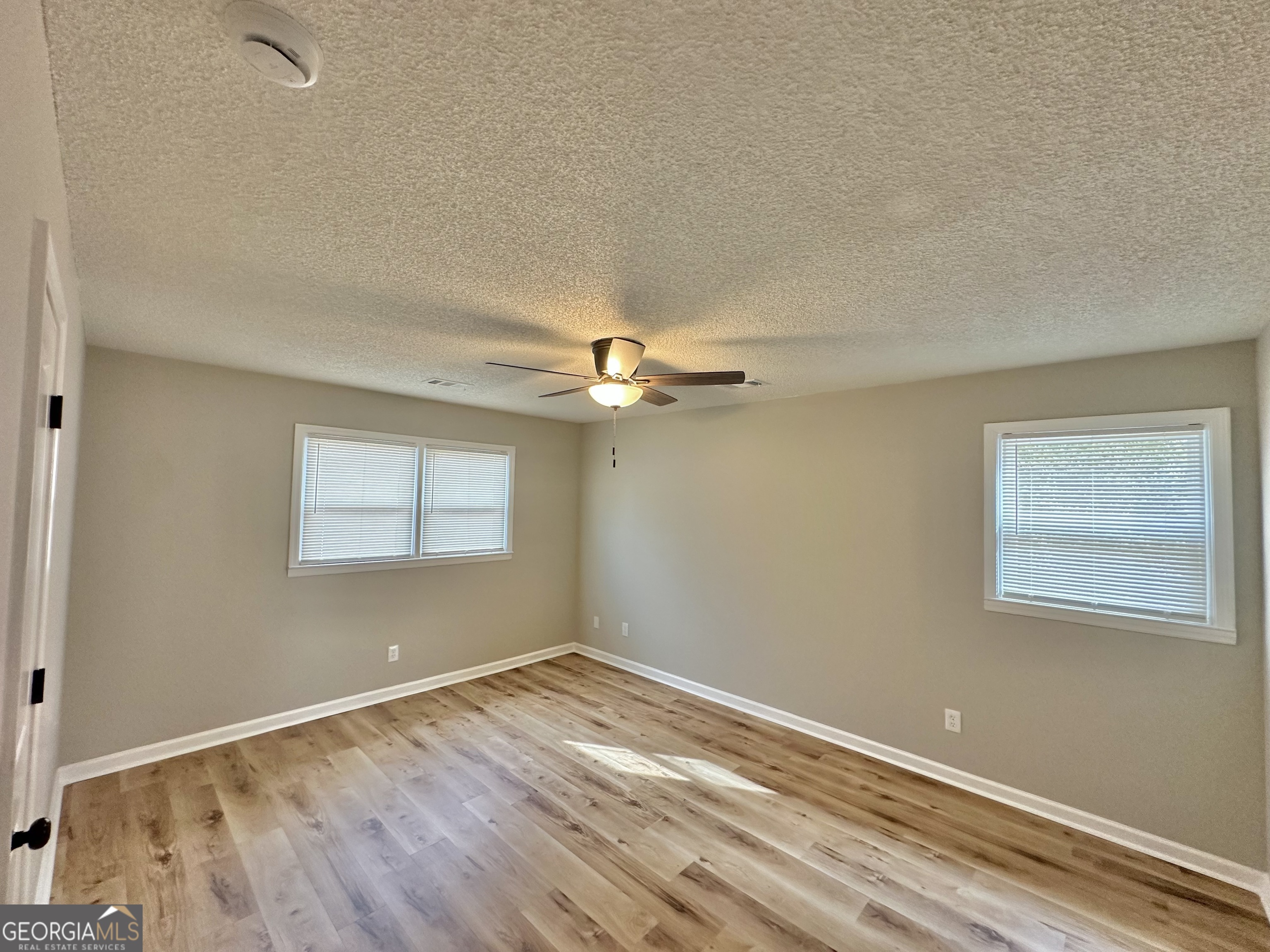 1610 Lance Drive Dublin, GA 31021 - Photo 33 of 38 a view of empty room with wooden floor and fan