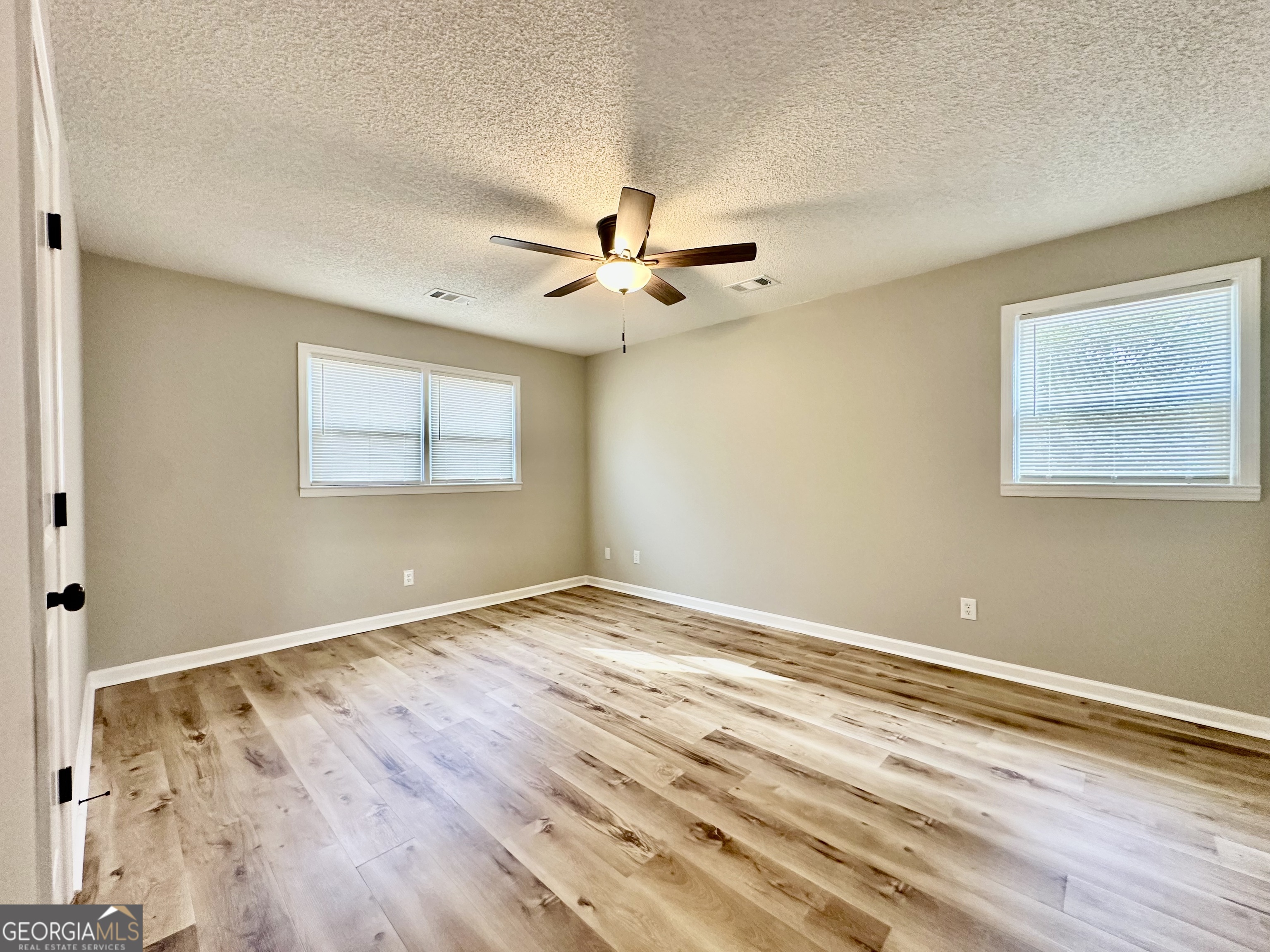 1610 Lance Drive Dublin, GA 31021 - Photo 34 of 38 a view of an empty room with window and a ceiling fan
