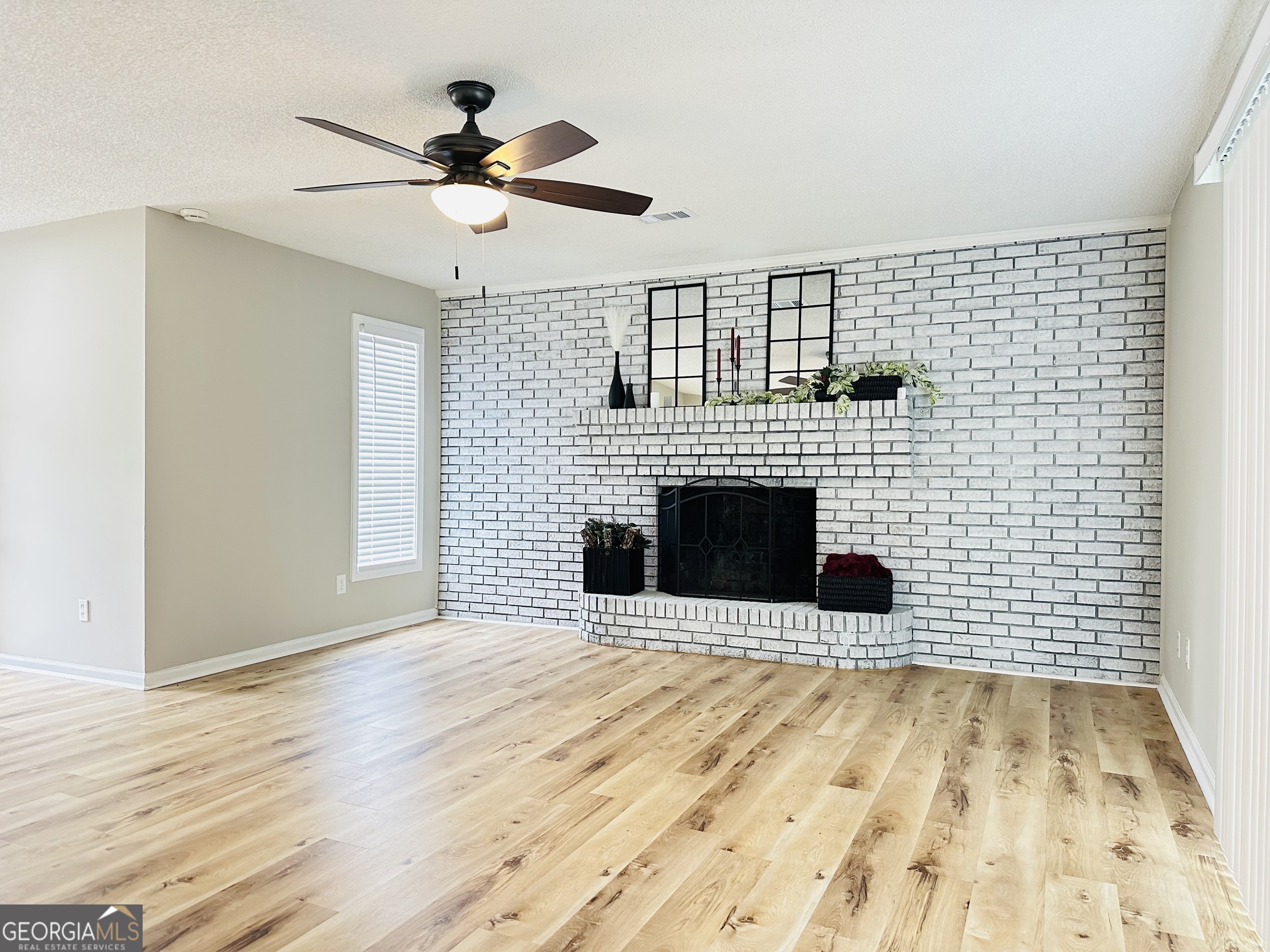1610 Lance Drive Dublin, GA 31021 - Photo 8 of 38 a view of a livingroom with a fireplace and wooden floor