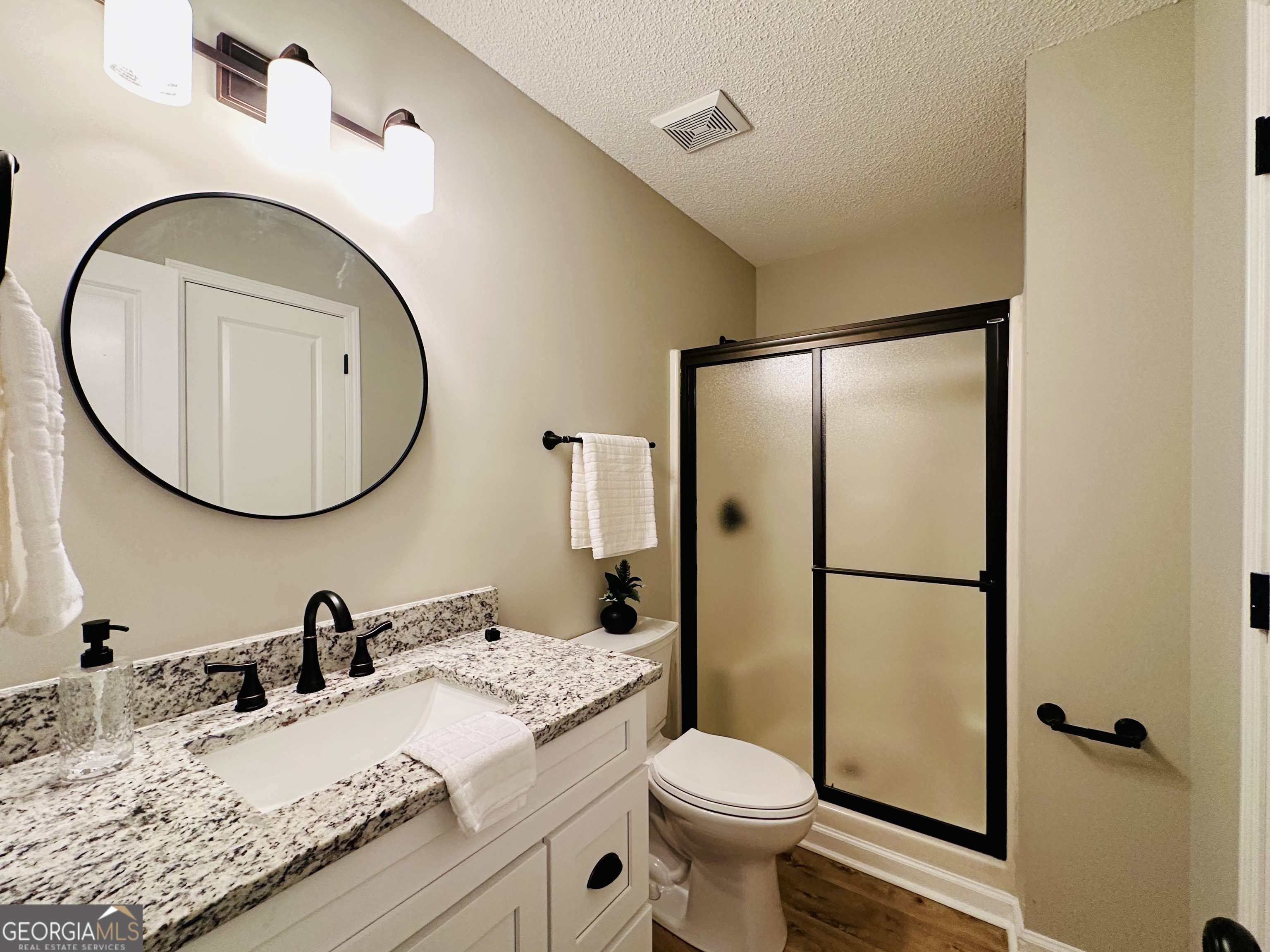 1610 Lance Drive Dublin, GA 31021 - Photo 9 of 38 a bathroom with a granite countertop sink toilet and a mirror