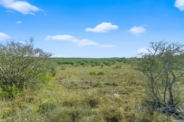 a view of a building in the middle of a field