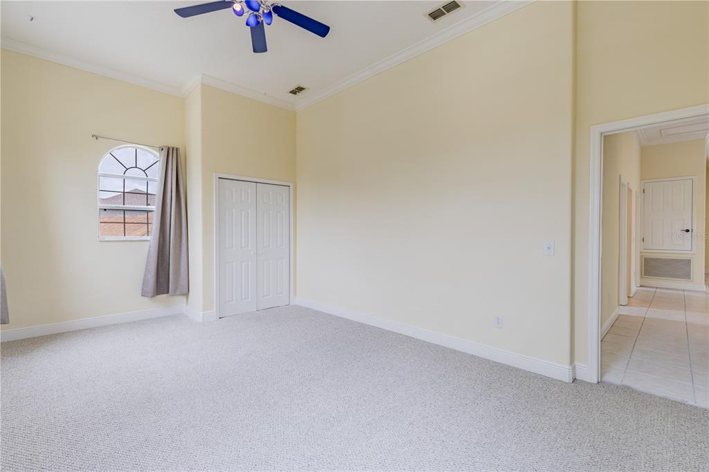 2718 Knightsbridge Road Clermont, FL 34711 - Photo 11 of 72 an empty room with chandelier fan and windows