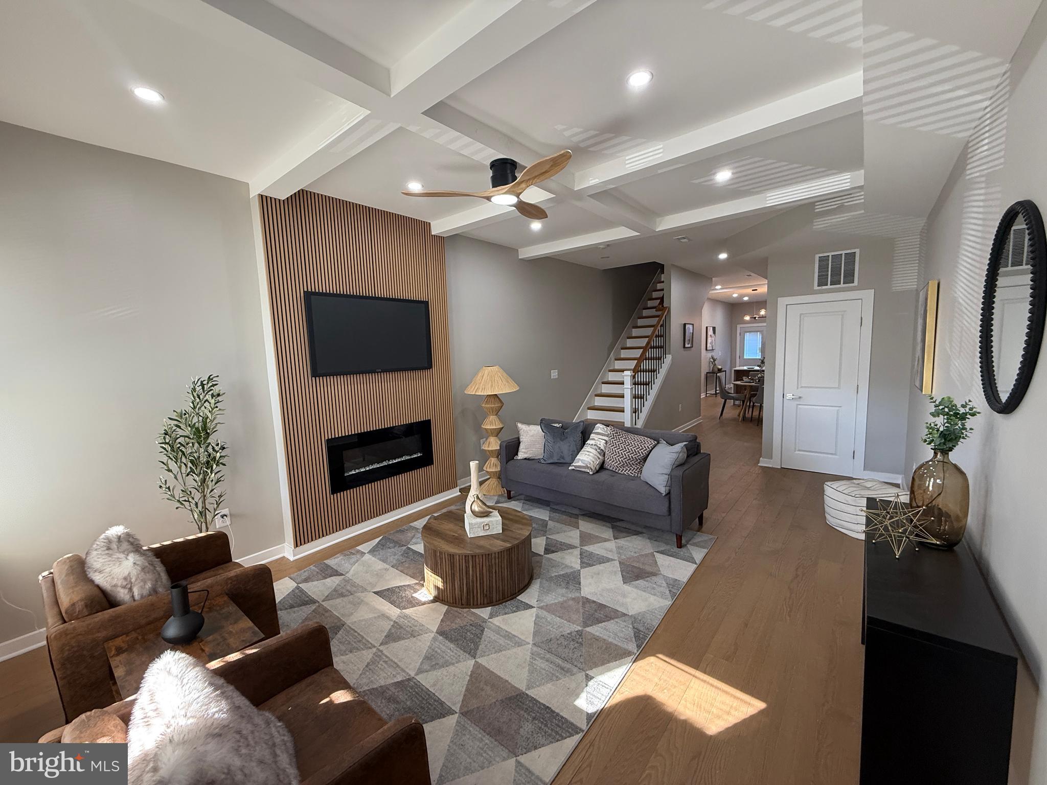 a living room with furniture a flat screen tv and a fireplace