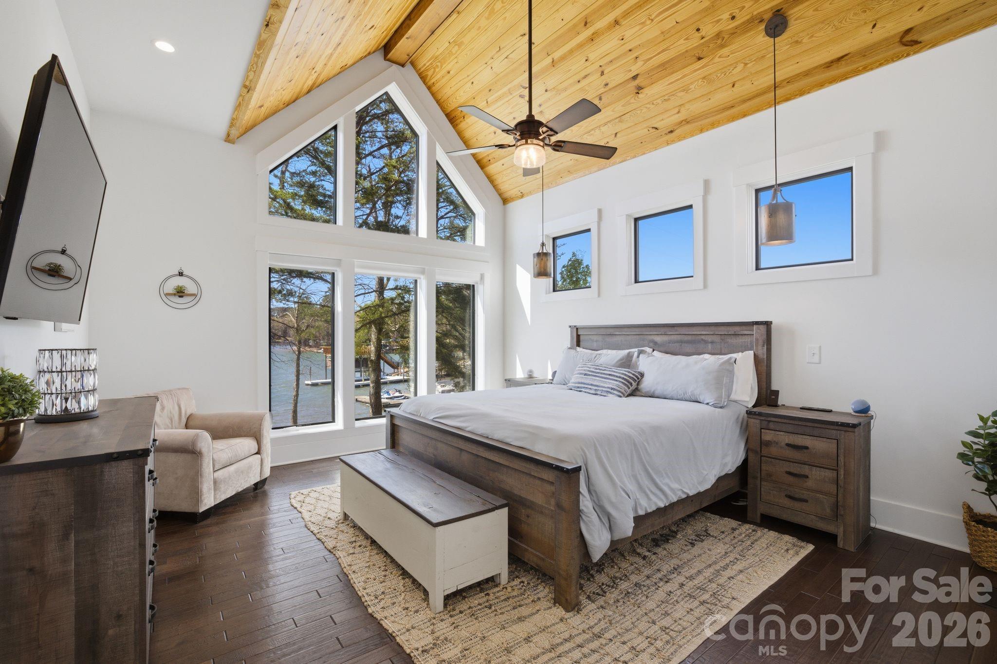7748 Harbor Lane Denver, NC 28037 - Photo 19 of 42 a spacious bedroom with a bed a mirror and a large window