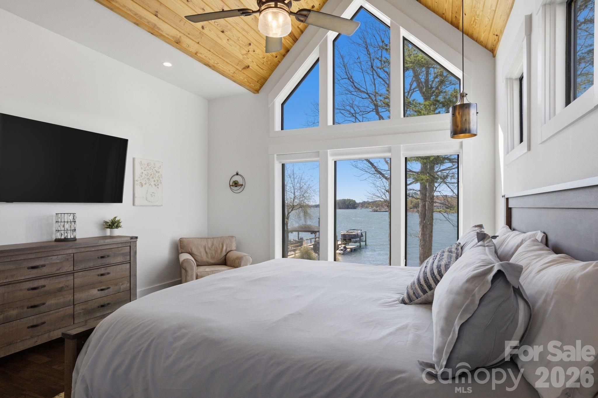7748 Harbor Lane Denver, NC 28037 - Photo 20 of 42 a bedroom with a large bed and a flat screen tv