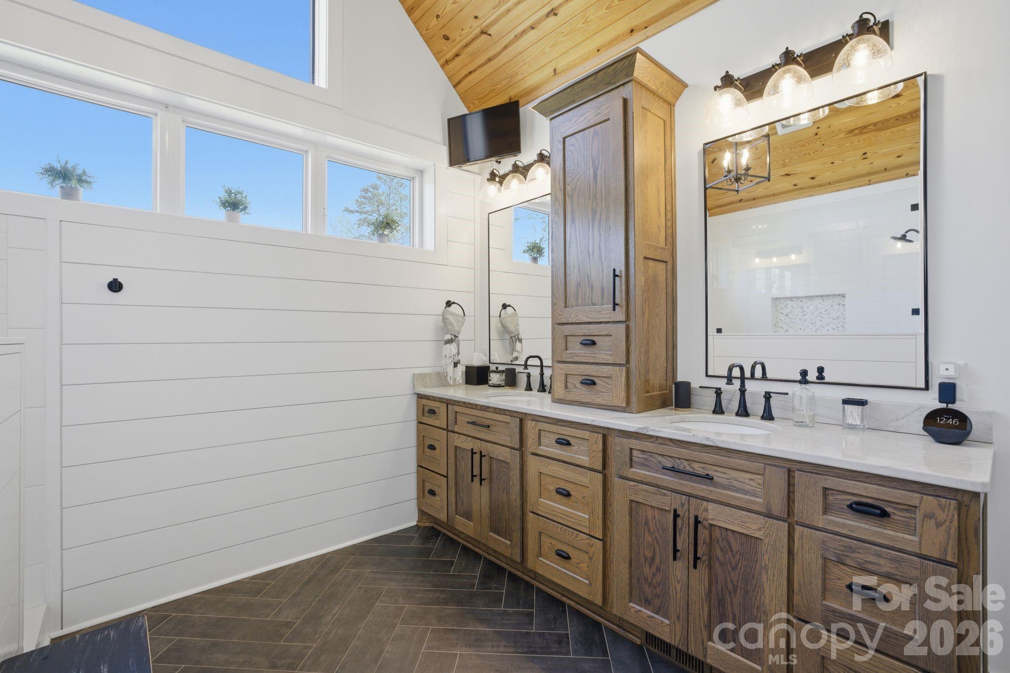 7748 Harbor Lane Denver, NC 28037 - Photo 23 of 42 a bathroom with a double vanity sink a mirror and a shower