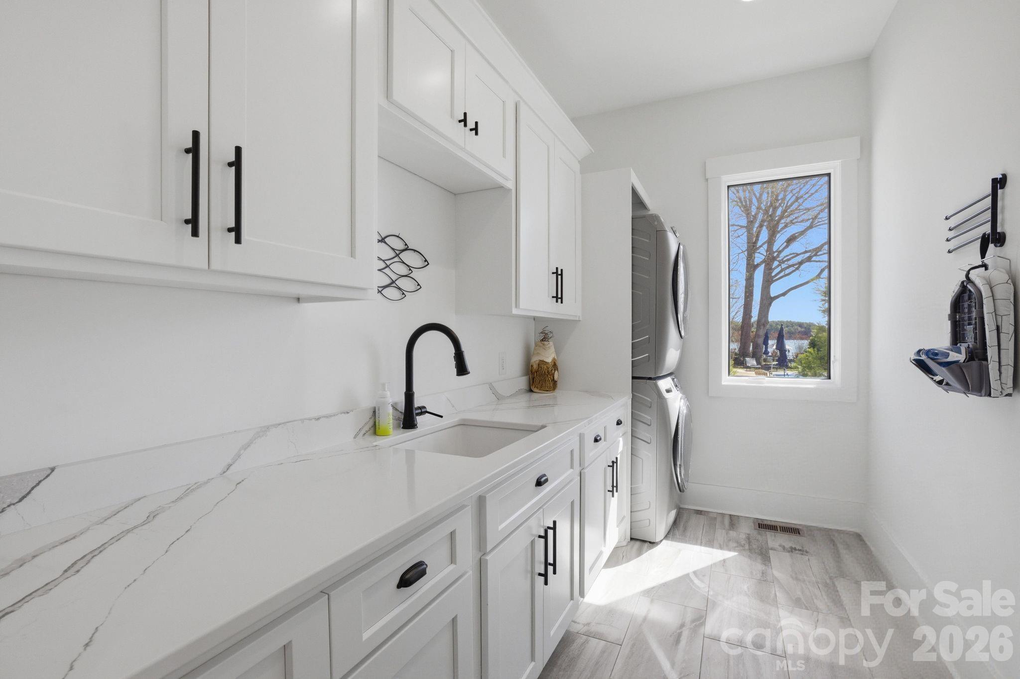 7748 Harbor Lane Denver, NC 28037 - Photo 26 of 42 a kitchen with stainless steel appliances a sink and cabinets