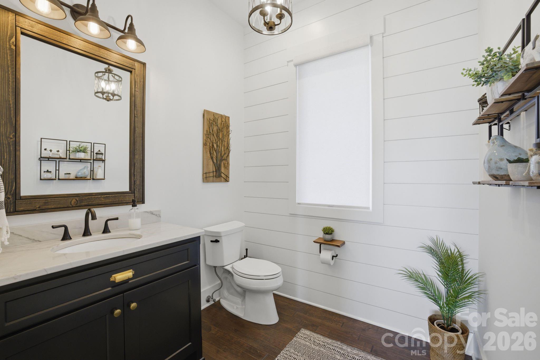 7748 Harbor Lane Denver, NC 28037 - Photo 27 of 42 a bathroom with a granite countertop sink toilet a mirror and shower