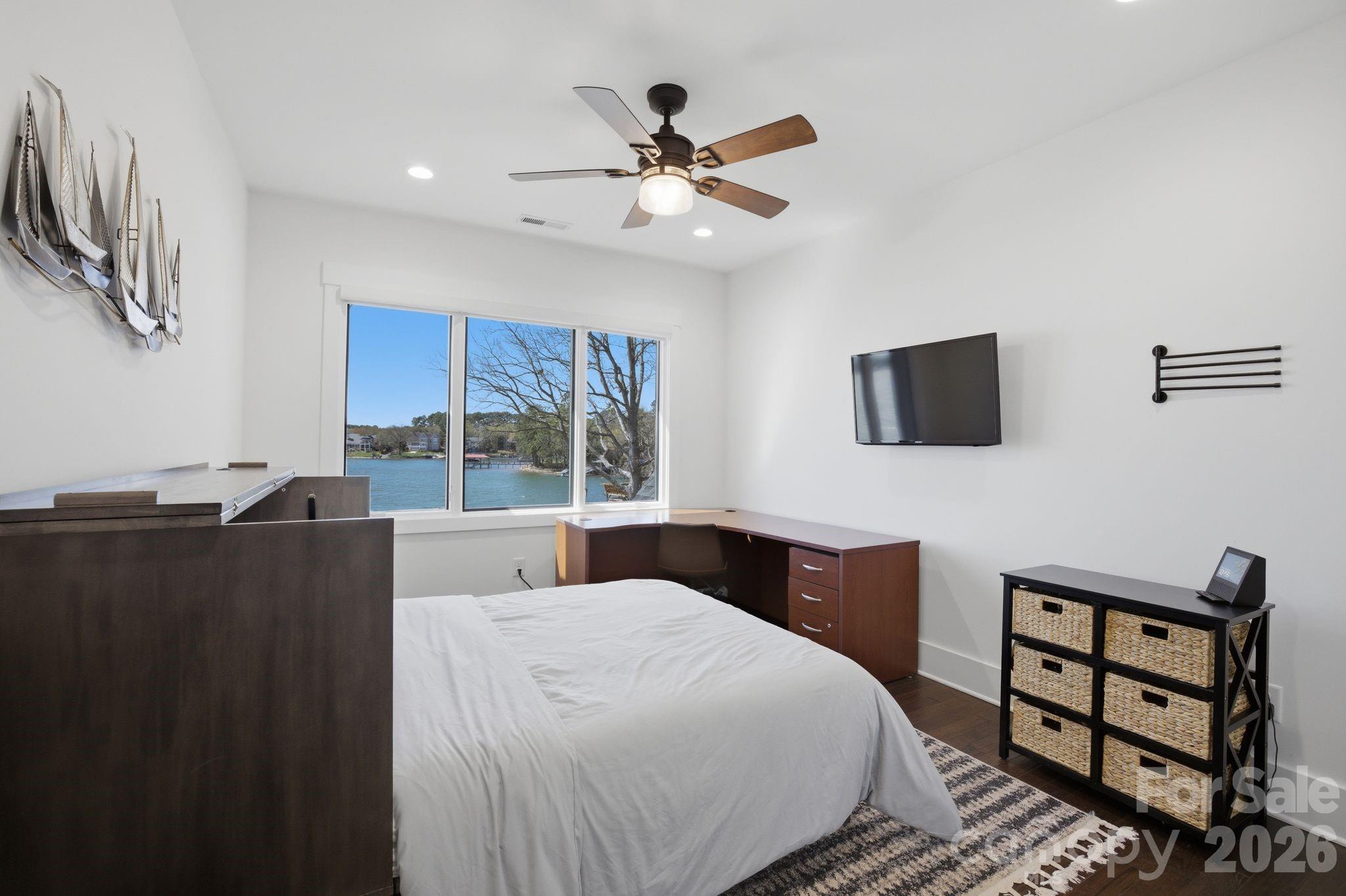 7748 Harbor Lane Denver, NC 28037 - Photo 30 of 42 a bedroom with a bed and a flat screen tv