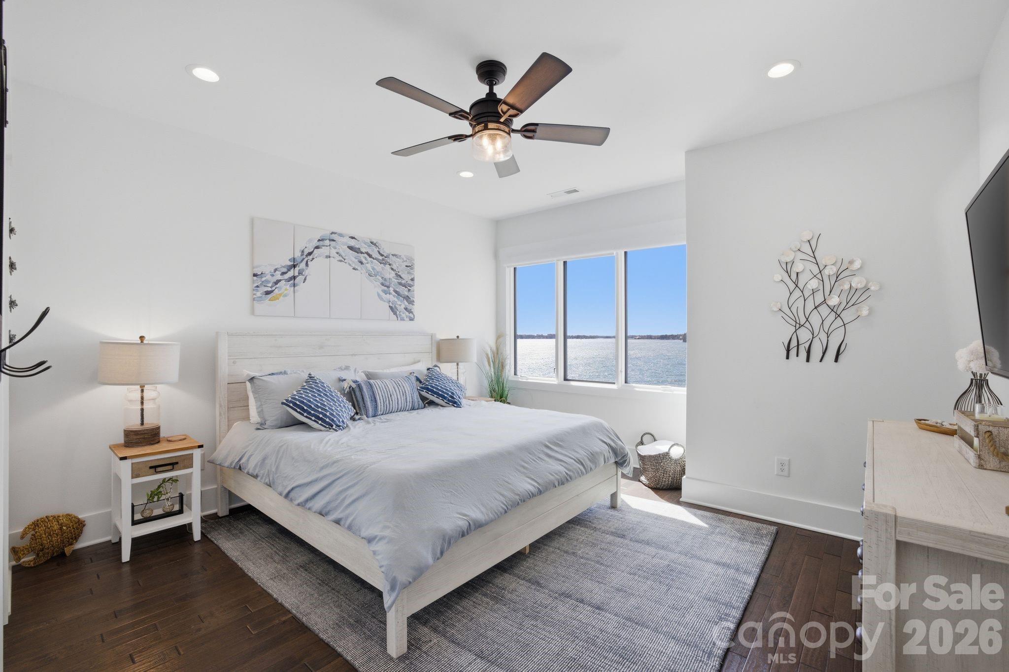 7748 Harbor Lane Denver, NC 28037 - Photo 34 of 42 a bedroom with a large bed and a ceiling fan