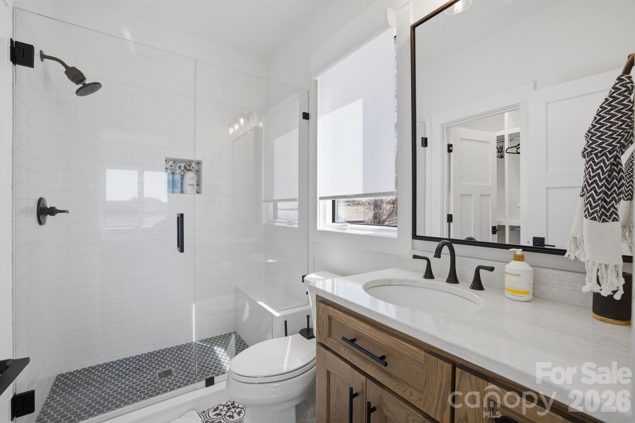 7748 Harbor Lane Denver, NC 28037 - Photo 38 of 42 a bathroom with a granite countertop sink a toilet and a mirror