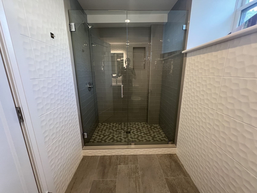 23 Winslow Road, Unit 1 Brookline, MA 02446 - Photo 22 of 27 a bathroom with a glass door shower