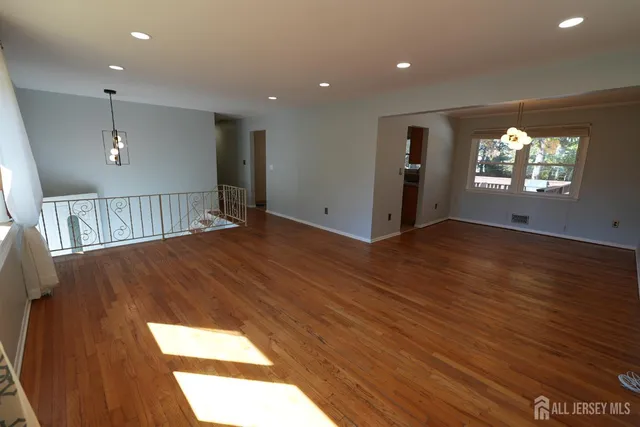 a view of livingroom with hardwood floor and hallway