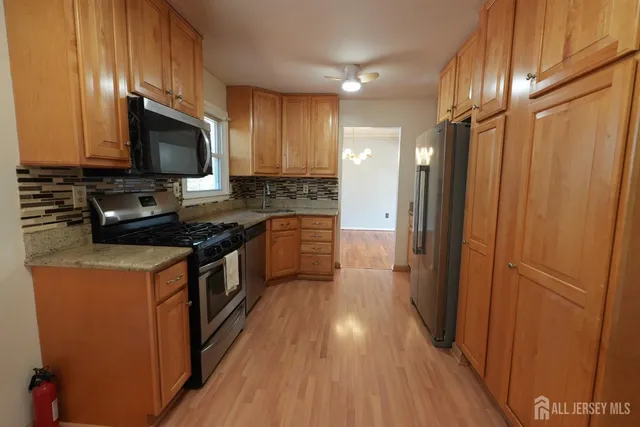 a kitchen with stainless steel appliances a refrigerator stove and microwave