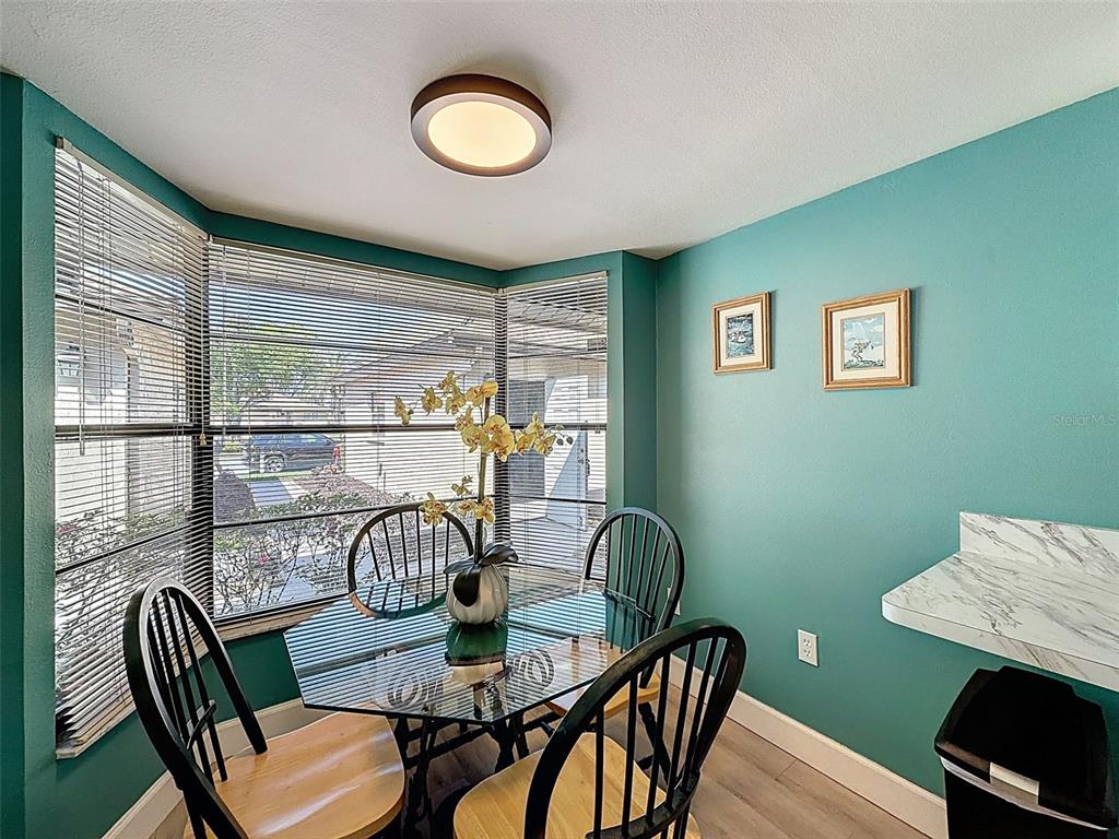 3504 Niblick Court, Unit 4 New Port Richey, FL 34655 - Photo 11 of 58 a view of a dining room with furniture window and wooden floor