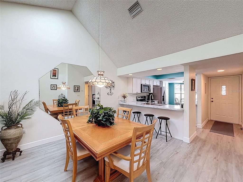 3504 Niblick Court, Unit 4 New Port Richey, FL 34655 - Photo 14 of 58 a view of a dining room with furniture and wooden floor