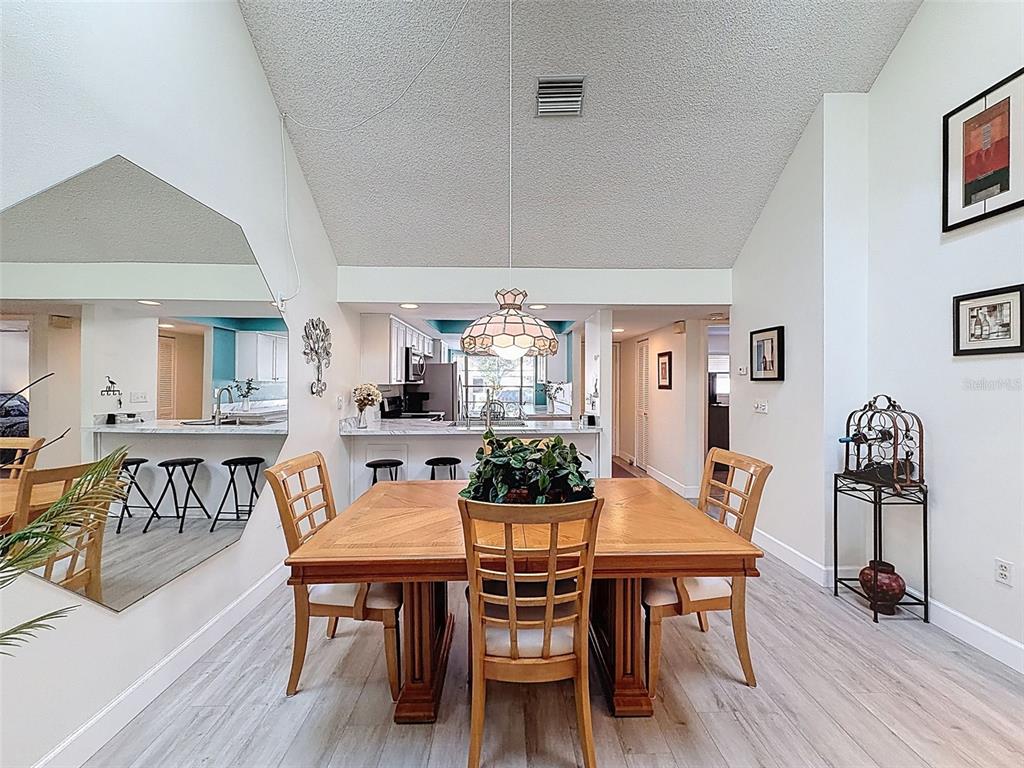 3504 Niblick Court, Unit 4 New Port Richey, FL 34655 - Photo 15 of 58 a view of a dining room with furniture and wooden floor
