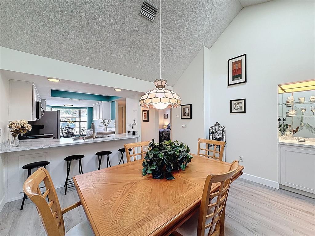 3504 Niblick Court, Unit 4 New Port Richey, FL 34655 - Photo 17 of 58 a view of a dining room with furniture and chandelier