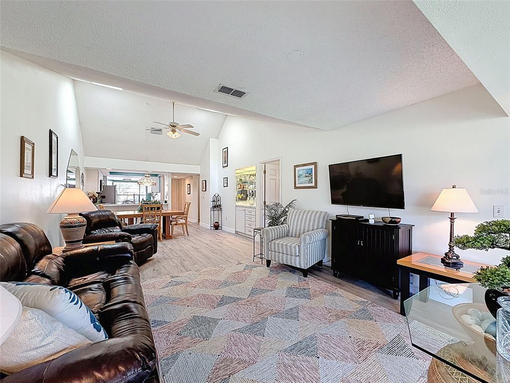 3504 Niblick Court, Unit 4 New Port Richey, FL 34655 - Photo 22 of 58 a living room with furniture and a flat screen tv