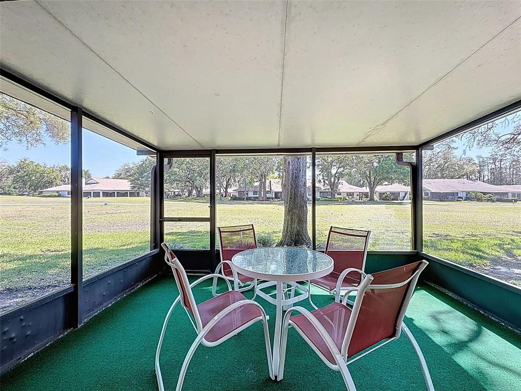 3504 Niblick Court, Unit 4 New Port Richey, FL 34655 - Photo 24 of 58 a view of a city from a dining room with large windows and wooden floor