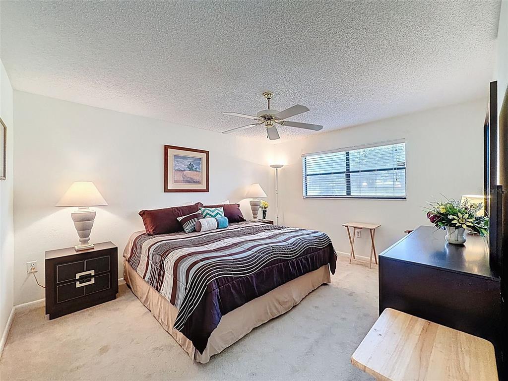 3504 Niblick Court, Unit 4 New Port Richey, FL 34655 - Photo 29 of 58 a spacious bedroom with a bed and window