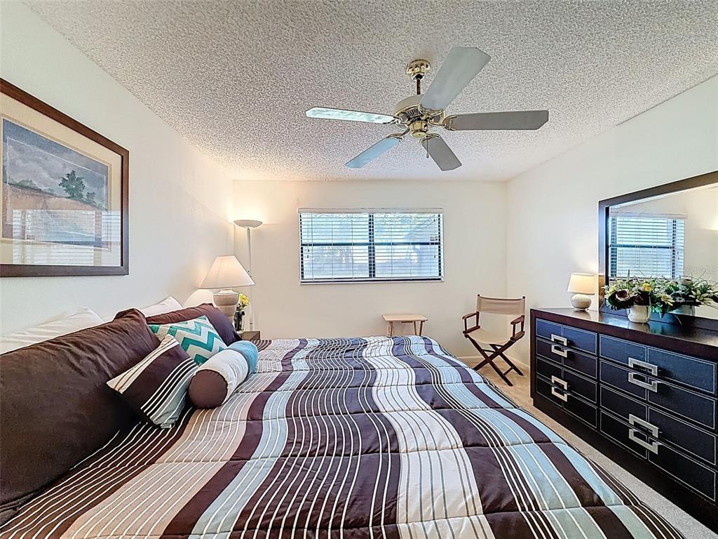 3504 Niblick Court, Unit 4 New Port Richey, FL 34655 - Photo 30 of 58 a bedroom with a bed and wooden floor