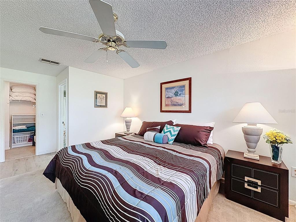 3504 Niblick Court, Unit 4 New Port Richey, FL 34655 - Photo 31 of 58 a bedroom with a bed and a chandelier
