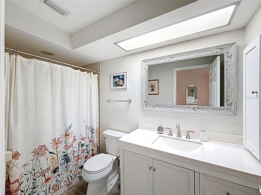 3504 Niblick Court, Unit 4 New Port Richey, FL 34655 - Photo 33 of 58 a bathroom with a granite countertop sink and a toilet