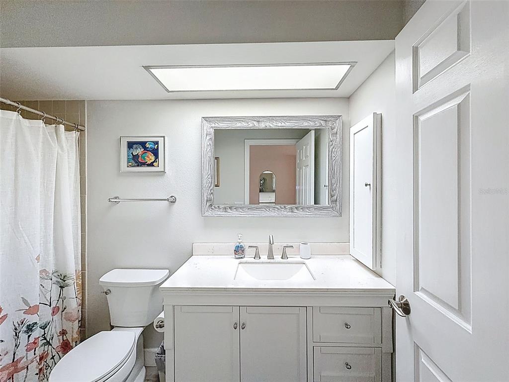3504 Niblick Court, Unit 4 New Port Richey, FL 34655 - Photo 35 of 58 a bathroom with a sink a toilet and a mirror