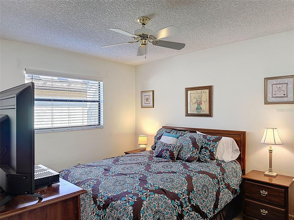 3504 Niblick Court, Unit 4 New Port Richey, FL 34655 - Photo 36 of 58 a bedroom with a large bed and a window