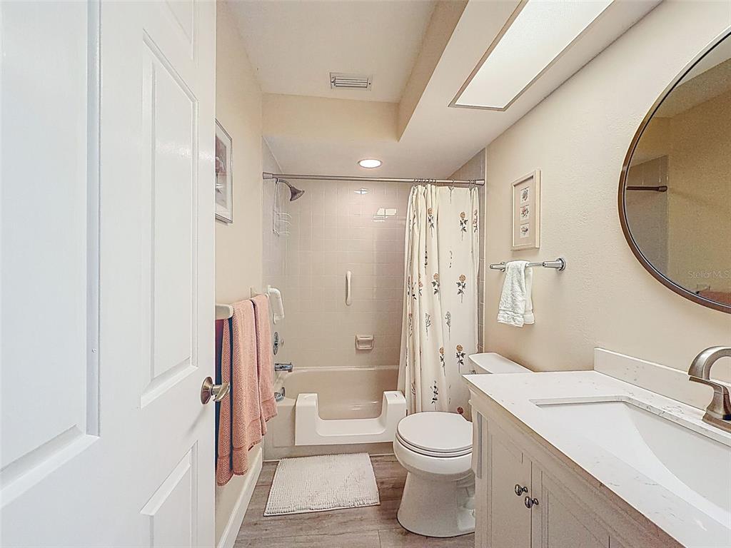 3504 Niblick Court, Unit 4 New Port Richey, FL 34655 - Photo 40 of 58 a bathroom with a sink a toilet and a large mirror