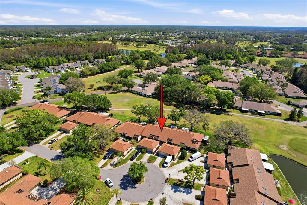3504 Niblick Court, Unit 4 New Port Richey, FL 34655 - Photo 45 of 58 an aerial view of residential houses with outdoor space and trees