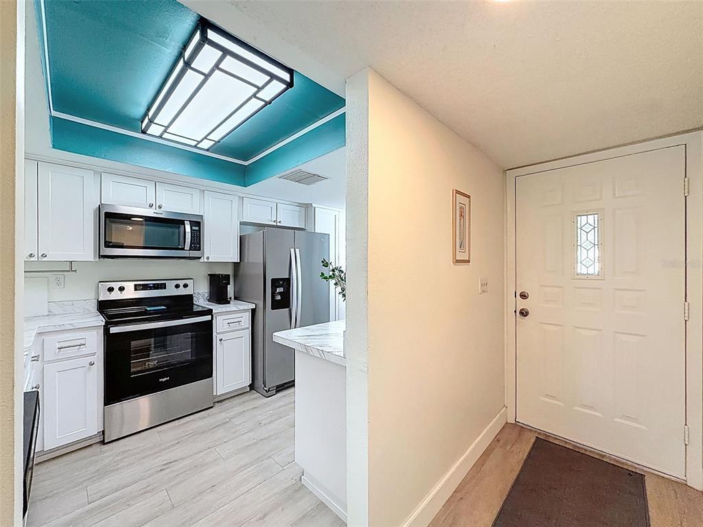3504 Niblick Court, Unit 4 New Port Richey, FL 34655 - Photo 5 of 58 a kitchen with stainless steel appliances a refrigerator and a stove top oven