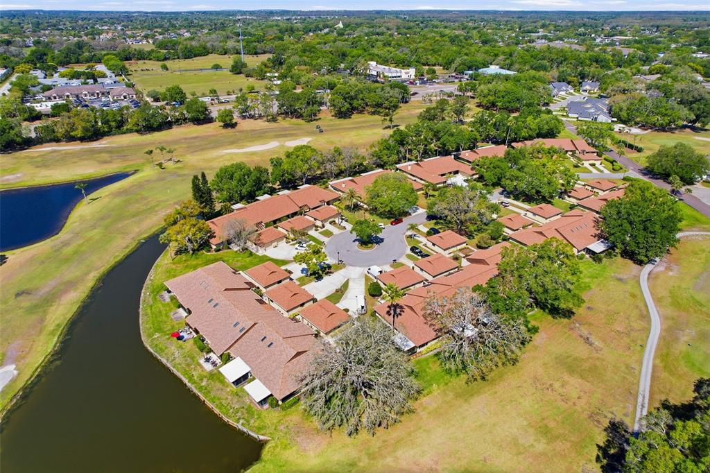 3504 Niblick Court, Unit 4 New Port Richey, FL 34655 - Photo 52 of 58 an aerial view of a house with a lake view