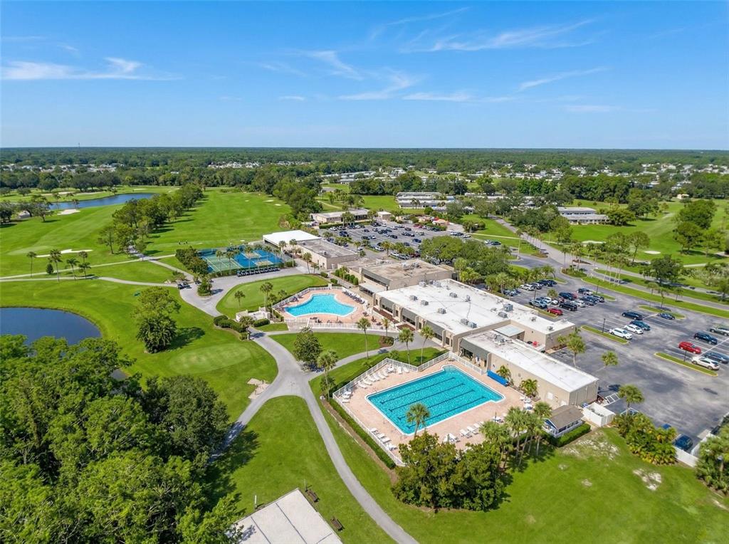 3504 Niblick Court, Unit 4 New Port Richey, FL 34655 - Photo 54 of 58 an aerial view of residential houses with outdoor space and trees all around