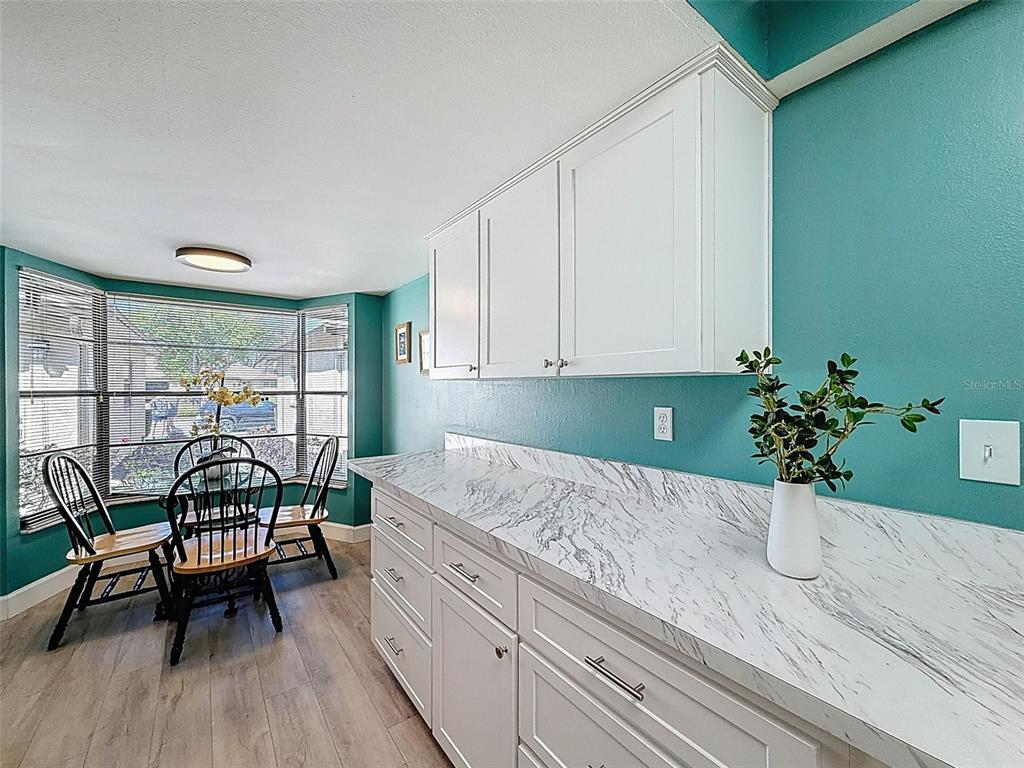 3504 Niblick Court, Unit 4 New Port Richey, FL 34655 - Photo 10 of 58 a kitchen with a table chairs and potted plant