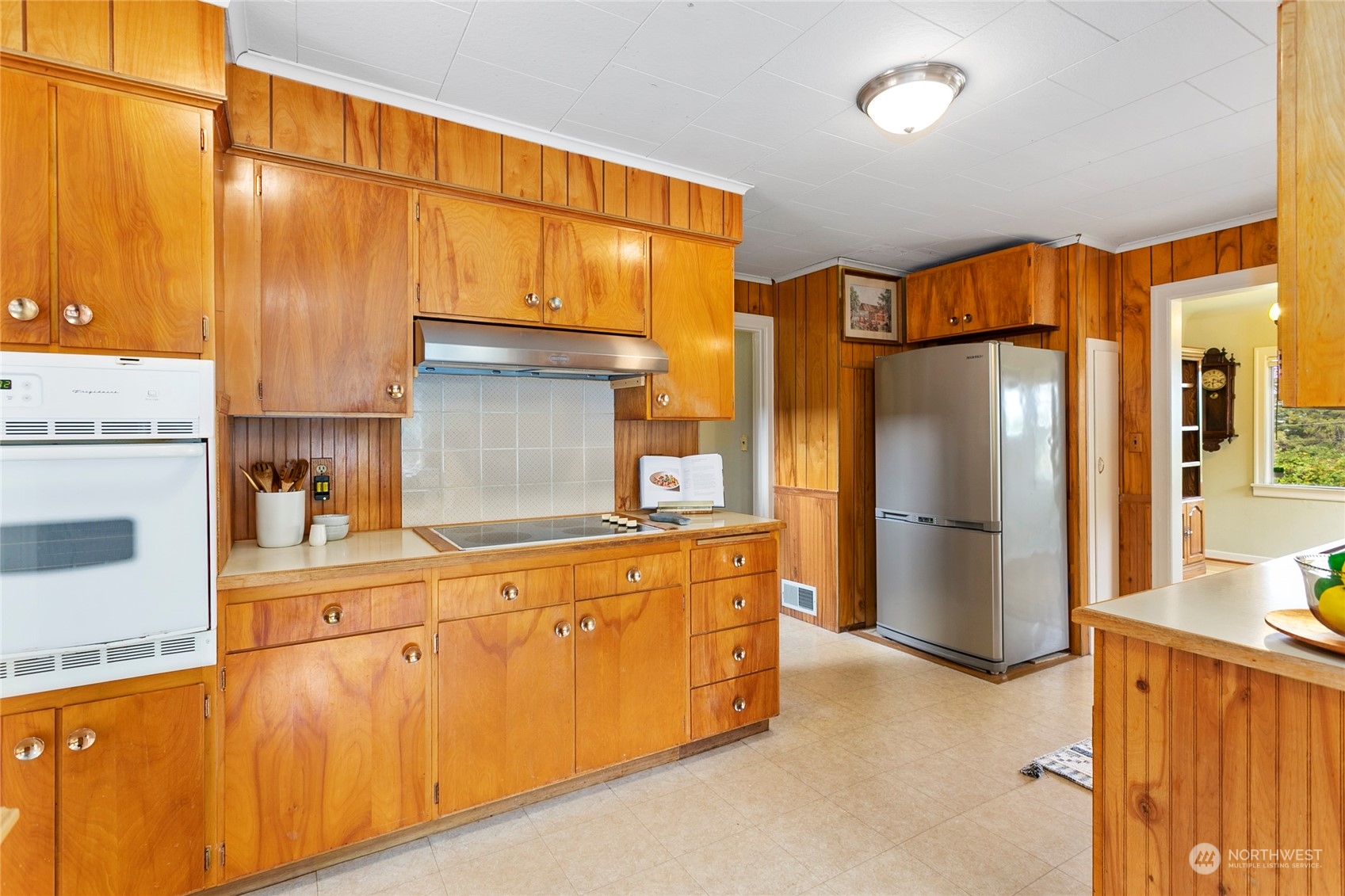 2219 Mt Baker Highway Bellingham, WA 98226 - Photo 13 of 39 a kitchen with stainless steel appliances granite countertop a refrigerator a oven and white cabinets with wooden floors
