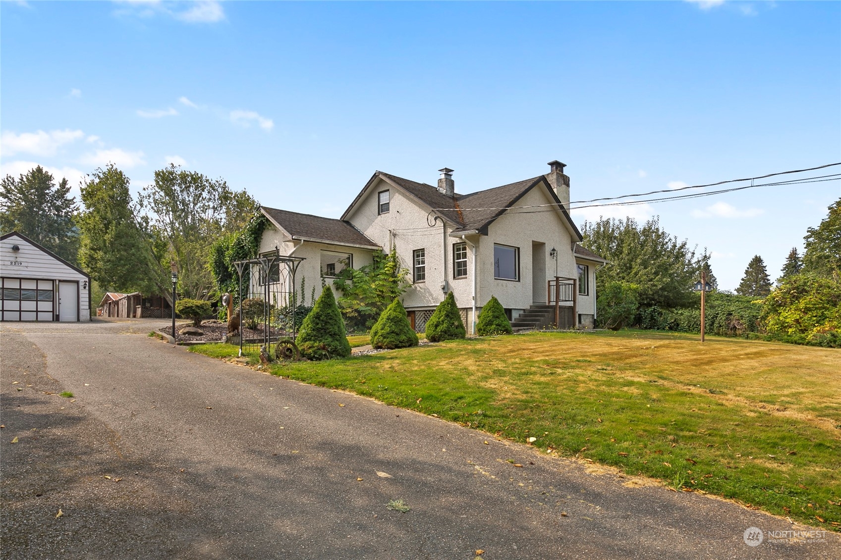 2219 Mt Baker Highway Bellingham, WA 98226 - Photo 3 of 39 a front view of a house with a yard and garage