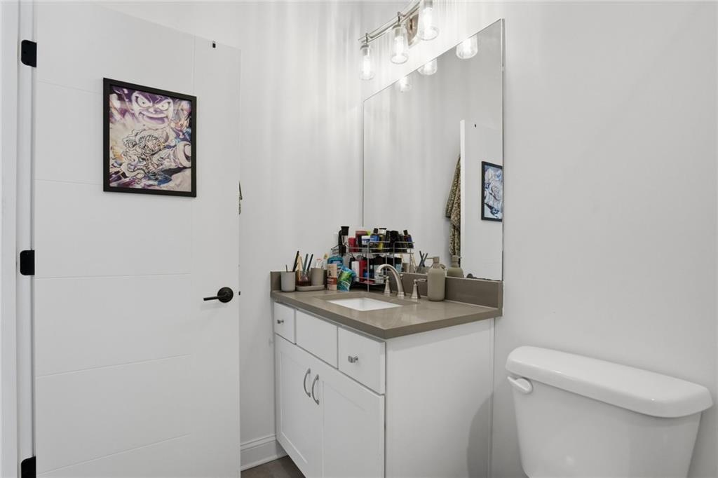 3020 Wallace Road Buford, GA 30519 - Photo 46 of 66 a bathroom with a sink vanity mirror and toilet