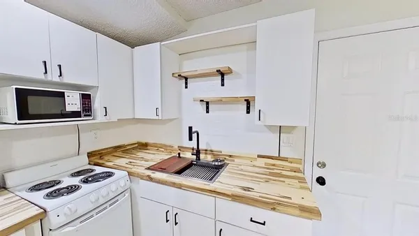 a kitchen with cabinets and appliances