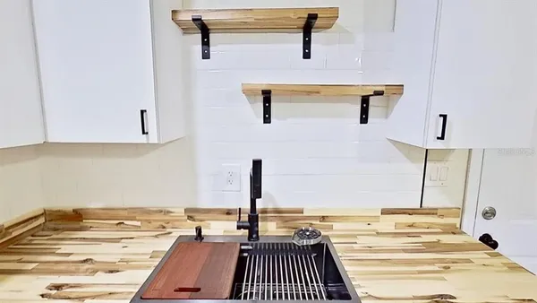 a view of a room with wooden floor and white walls