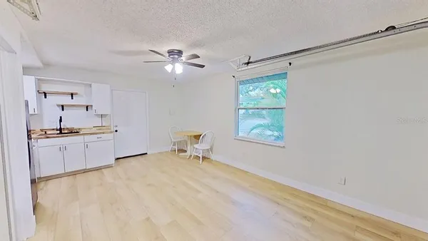 a view of a room with a table and chairs in it