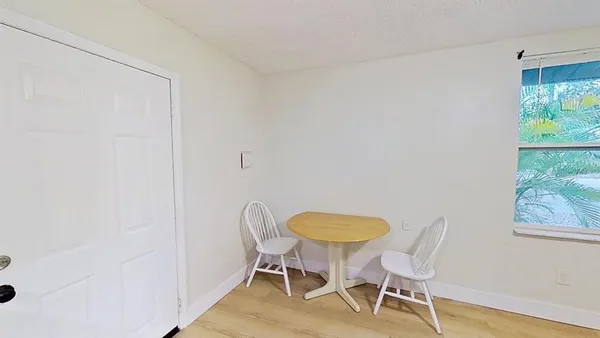 a view of hallway with a ceiling fan and a window