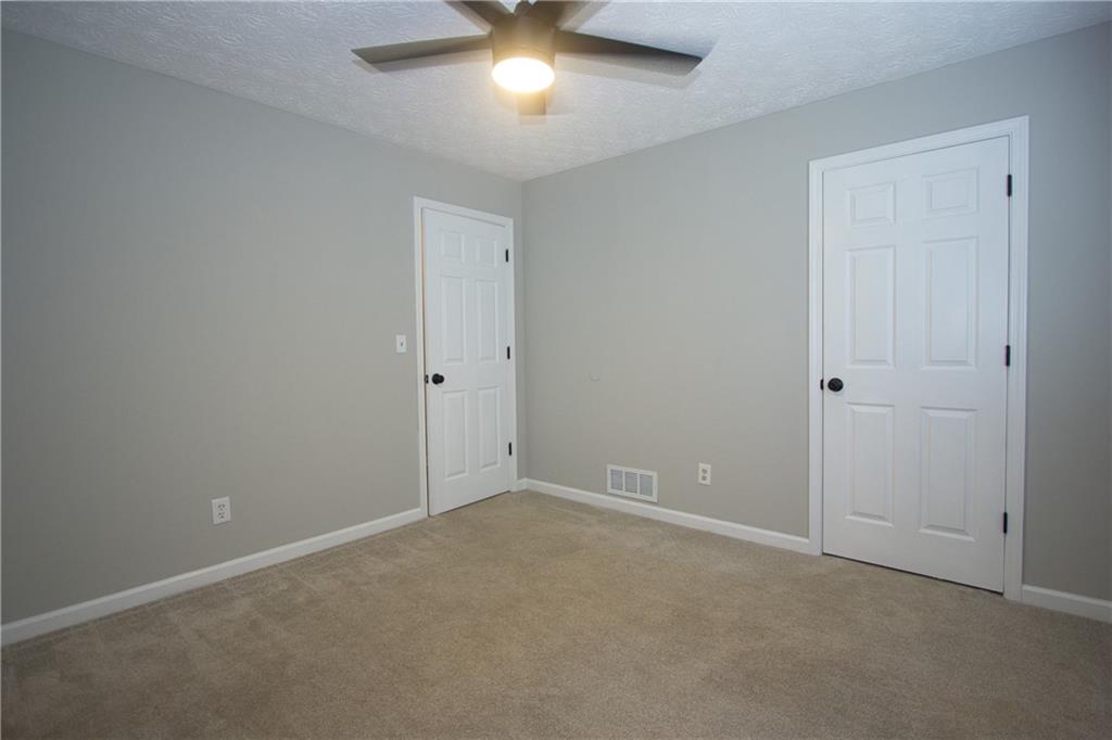 374 McGiboney Road Covington, GA 30016 - Photo 25 of 29 a view of an empty room with a chandelier fan