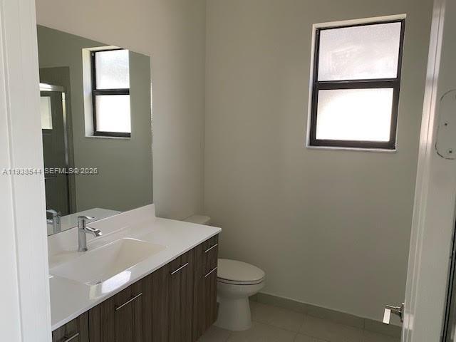 4435 Southwest 174th Avenue Miramar, FL 33029 - Photo 19 of 34 a bathroom with a toilet sink and mirror