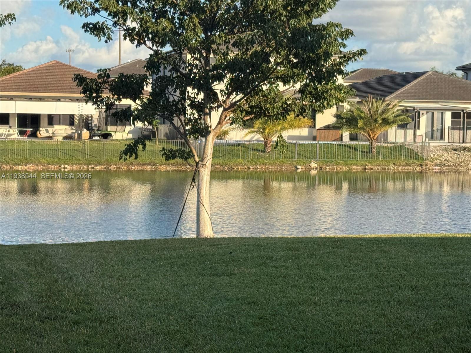 4435 Southwest 174th Avenue Miramar, FL 33029 - Photo 32 of 34 a view of a lake with a yard and large trees