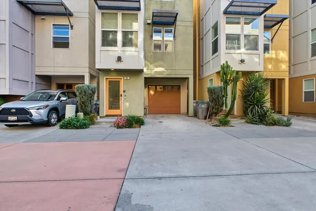 a view of backyard with potted plants and a table and chair