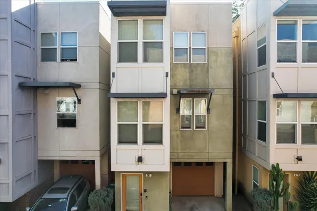 an aerial view of residential houses with outdoor space