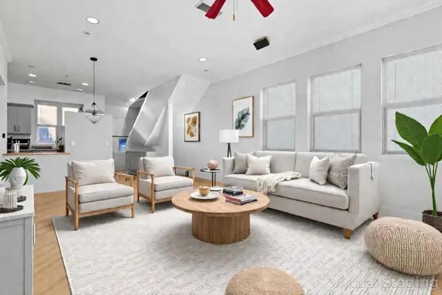 a living room with furniture and a potted plant